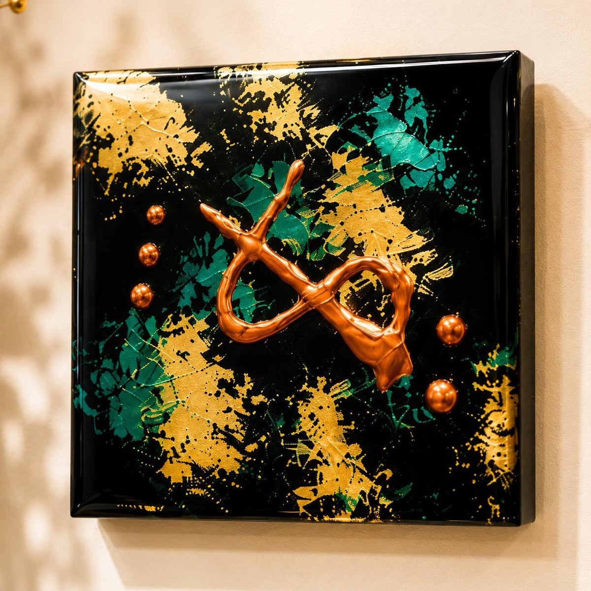 Close-up of a Copper Current 4×4 wood panel with raised copper forms, teal and gold marks on a glossy black background