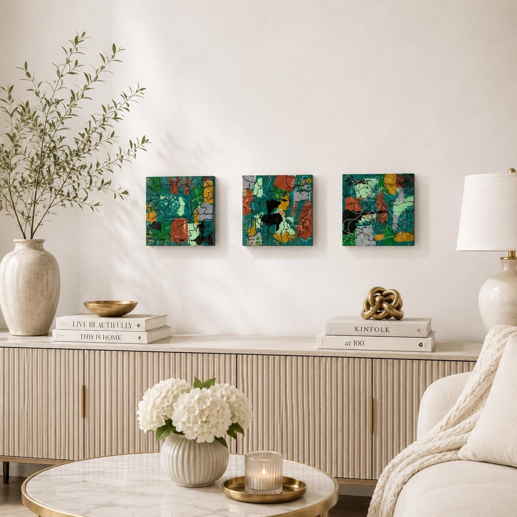 Three Emerald Mosaic 4×4 abstract wood panels displayed in a row above a living room console