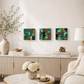 Three Emerald Mosaic 4×4 abstract wood panels displayed in a row above a living room console